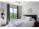 Inviting bedroom with a large window offering views of the desert landscape beyond at 19550 N Grayhawk Dr # 2023, Scottsdale, AZ 85255