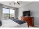 Bedroom features a large dresser and access to a balcony with mountain views at 19550 N Grayhawk Dr # 2023, Scottsdale, AZ 85255