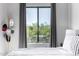 Inviting bedroom with a large window offering views of the desert landscape beyond at 19550 N Grayhawk Dr # 2023, Scottsdale, AZ 85255