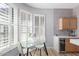 Bright breakfast nook featuring a glass table, seating for two, and lovely plantation shutters at 19550 N Grayhawk Dr # 2023, Scottsdale, AZ 85255