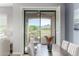 Serene dining room offering scenic views, plantation shutters, and contemporary decor at 19550 N Grayhawk Dr # 2023, Scottsdale, AZ 85255