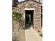 Charming entranceway with stone detail and a desert-friendly landscaped walkway at 19550 N Grayhawk Dr # 2023, Scottsdale, AZ 85255