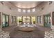 Circular courtyard featuring a tiered water fountain, arched openings, and green doors at 19550 N Grayhawk Dr # 2023, Scottsdale, AZ 85255