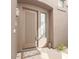 Stylish front door with decorative window, a welcoming mat, and potted greenery at 19550 N Grayhawk Dr # 2023, Scottsdale, AZ 85255