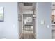 Hallway featuring neutral paint, wood floors, artwork, and access to other rooms in the home at 19550 N Grayhawk Dr # 2023, Scottsdale, AZ 85255