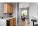 Modern kitchen with bar seating and a dining area off in the background, and a sleek wine cooler at 19550 N Grayhawk Dr # 2023, Scottsdale, AZ 85255
