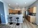 Kitchen featuring bar seating, stainless steel appliances, and ample cabinet space at 19550 N Grayhawk Dr # 2023, Scottsdale, AZ 85255