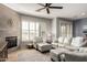 Bright living room featuring a fireplace, plush seating, and abundant natural light at 19550 N Grayhawk Dr # 2023, Scottsdale, AZ 85255