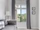 Comfortable living room with a large window offering views of the desert landscape beyond at 19550 N Grayhawk Dr # 2023, Scottsdale, AZ 85255