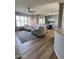 Open-concept living area with modern furnishings, plantation shutters, and wood-look tile floors at 19550 N Grayhawk Dr # 2023, Scottsdale, AZ 85255