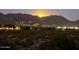 Scenic night view of the desert homes nestled against the mountains, illuminated by the moon and house lights at 19550 N Grayhawk Dr # 2023, Scottsdale, AZ 85255