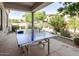 Covered outdoor game area featuring a ping pong table with desert landscaping at 19550 N Grayhawk Dr # 2023, Scottsdale, AZ 85255
