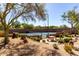 Outdoor tennis court in a landscaped setting with desert plants and a picnic table at 19550 N Grayhawk Dr # 2023, Scottsdale, AZ 85255