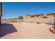Large gravel backyard with block wall, desert landscaping, and a view of the two-story home at 1956 N Hubbard Ln, Casa Grande, AZ 85122