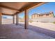 Spacious backyard featuring a covered patio, gravel landscaping, and block wall fencing for privacy at 1956 N Hubbard Ln, Casa Grande, AZ 85122