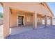Backyard featuring a covered patio, sliding glass door, and desert-friendly gravel landscaping at 1956 N Hubbard Ln, Casa Grande, AZ 85122
