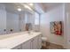 Well-lit bathroom featuring a vanity, large mirror, and a shower-tub combination at 1956 N Hubbard Ln, Casa Grande, AZ 85122