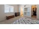 Bedroom featuring a window, access to the bathroom and walk-in closet with built-in shelving at 1956 N Hubbard Ln, Casa Grande, AZ 85122