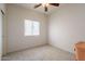 This bedroom features a ceiling fan, window with blinds, and carpeted flooring at 1956 N Hubbard Ln, Casa Grande, AZ 85122