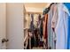 Walk-in closet with clothes hanging on the rods and shelves for storing personal items at 1956 N Hubbard Ln, Casa Grande, AZ 85122
