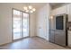 Dining area with modern chandelier, stainless refrigerator, and sliding glass door at 1956 N Hubbard Ln, Casa Grande, AZ 85122