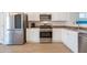 Well-lit kitchen features stainless steel appliances and sleek white cabinetry at 1956 N Hubbard Ln, Casa Grande, AZ 85122