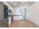 Modern kitchen featuring stainless steel appliances, white cabinets, and an open layout at 1956 N Hubbard Ln, Casa Grande, AZ 85122