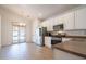 Eat-in kitchen featuring white cabinetry, stainless appliances, and access to outdoor patio at 1956 N Hubbard Ln, Casa Grande, AZ 85122