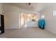Bright and open living room with arches connecting to the kitchen and dining areas at 1956 N Hubbard Ln, Casa Grande, AZ 85122