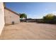Exterior shot of the backyard, showcasing desert landscaping, and a secured metal fence at 19880 W Desert Views Dr, Casa Grande, AZ 85122