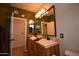 Bright bathroom featuring double vanities with ornate lighting and a large mirror above at 19880 W Desert Views Dr, Casa Grande, AZ 85122