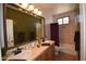 Bathroom features dual sinks, decorative mirror, and a shower/tub combination at 19880 W Desert Views Dr, Casa Grande, AZ 85122