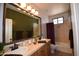 Bathroom featuring double vanities, ornate lighting, and a seperate bathtub and shower at 19880 W Desert Views Dr, Casa Grande, AZ 85122