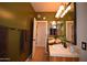 Well lit bathroom featuring double vanities, ornate lighting, and a door to another room at 19880 W Desert Views Dr, Casa Grande, AZ 85122