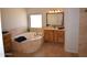 Bright primary bathroom with a corner tub, double vanities, and natural light at 19880 W Desert Views Dr, Casa Grande, AZ 85122