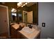 Bathroom featuring double vanities, ornate lighting, and a door to another room at 19880 W Desert Views Dr, Casa Grande, AZ 85122