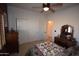 Cozy bedroom featuring neutral carpet, ample closet space, and a ceiling fan for added comfort at 19880 W Desert Views Dr, Casa Grande, AZ 85122