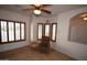 Serene bedroom with shutters, natural light, tile floors, and comfortable seating area at 19880 W Desert Views Dr, Casa Grande, AZ 85122
