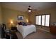 Inviting bedroom featuring a ceiling fan and a window with stylish shutters for added privacy and comfort at 19880 W Desert Views Dr, Casa Grande, AZ 85122
