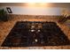 GE Profile cooktop on a kitchen counter with granite countertop at 19880 W Desert Views Dr, Casa Grande, AZ 85122