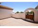 Private courtyard with an arched entrance and mature landscaping at 19880 W Desert Views Dr, Casa Grande, AZ 85122