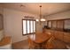Dining room with natural wood table, chandelier, and window with wooden shutters at 19880 W Desert Views Dr, Casa Grande, AZ 85122