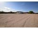 Expansive lot with an exterior building featuring roll up doors and ample parking space for various needs at 19880 W Desert Views Dr, Casa Grande, AZ 85122