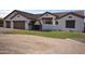 Elegant single-story home featuring a tile roof, stucco facade, and a beautifully landscaped front yard with desert accents at 19880 W Desert Views Dr, Casa Grande, AZ 85122