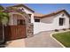 Charming home exterior with a gated courtyard, stone accents, and a red tile roof at 19880 W Desert Views Dr, Casa Grande, AZ 85122