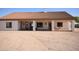 Exterior view showcases a covered patio and well lit seating area for outdoor relaxation with ample parking at 19880 W Desert Views Dr, Casa Grande, AZ 85122