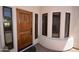 Beautiful wooden front door with sidelights and transom window, creating a grand entrance at 19880 W Desert Views Dr, Casa Grande, AZ 85122