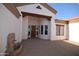 Inviting front entrance with a fountain, wooden beam, and a wood front door, complemented by a neutral color palette at 19880 W Desert Views Dr, Casa Grande, AZ 85122
