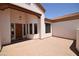 Inviting front entrance with wood beams, a custom door, and a spacious courtyard at 19880 W Desert Views Dr, Casa Grande, AZ 85122