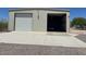 Exterior of a gray steel garage, concrete driveway, and roll up door, offering ample storage space at 19880 W Desert Views Dr, Casa Grande, AZ 85122